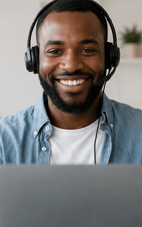 Smiling man wearing a headset with a microphone in a bright workspace